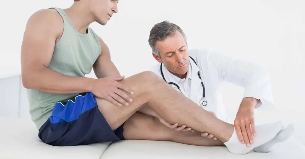 A doctor examining a patient's leg