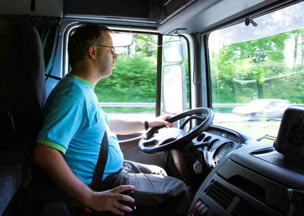 The truck driver sitting on the seat cushion