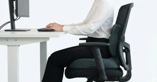 Side view of person with perfect posture using SitCushion and lumbar support on an office chair